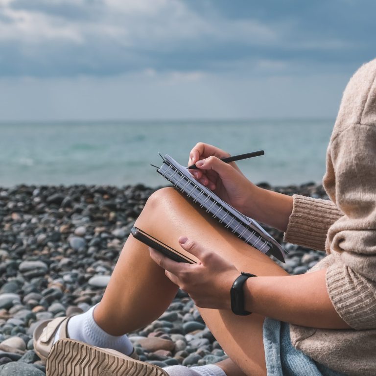 Workplace sea.Remote work.Girl freelancer works remotely on the seashore.workation, remote work,WFVH,Van Life vibes work from vacation home,work travel,remotely work.Travelling